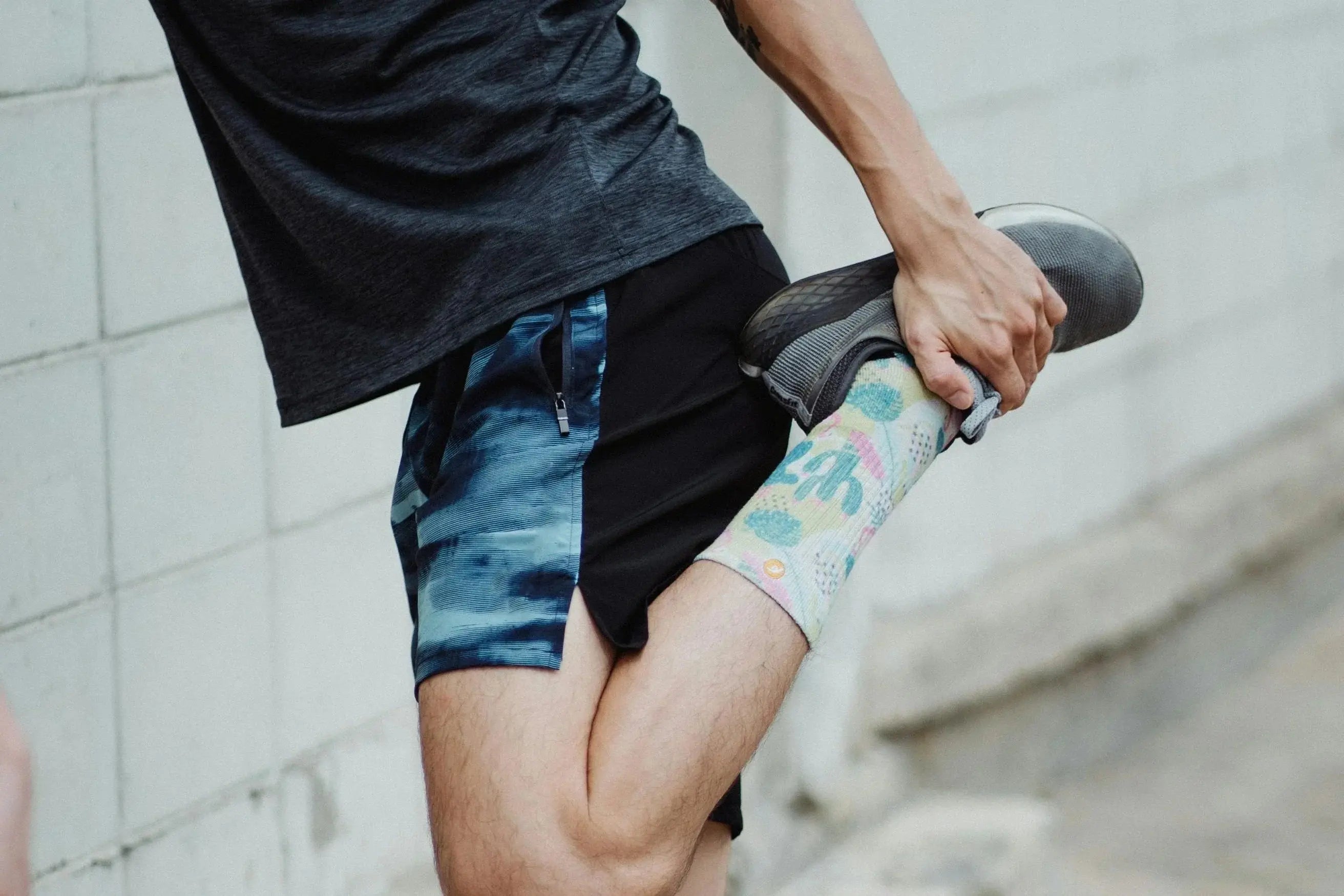 person strecthing their knee preparing for an activity