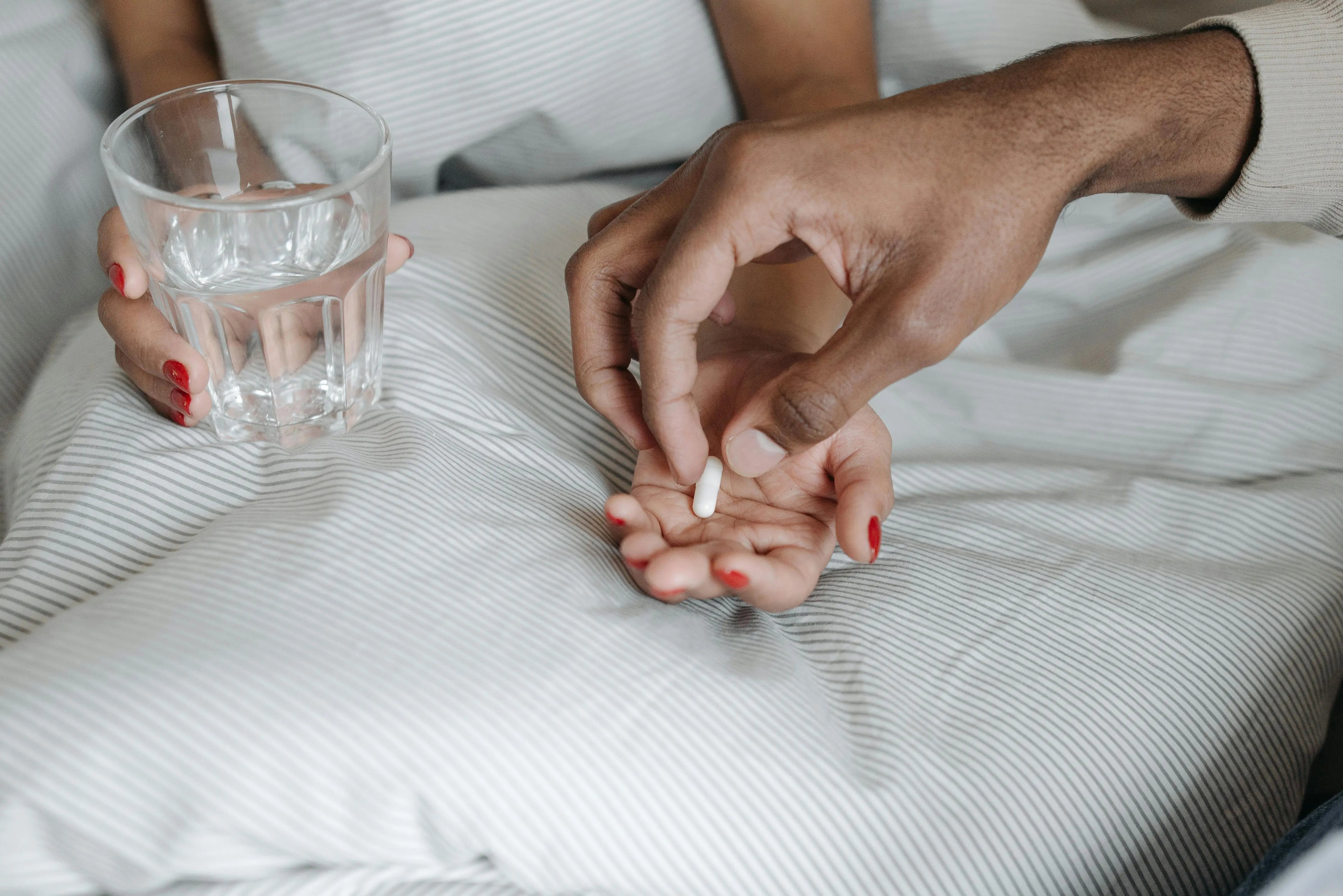 a person on the bed with melatonin supplements
