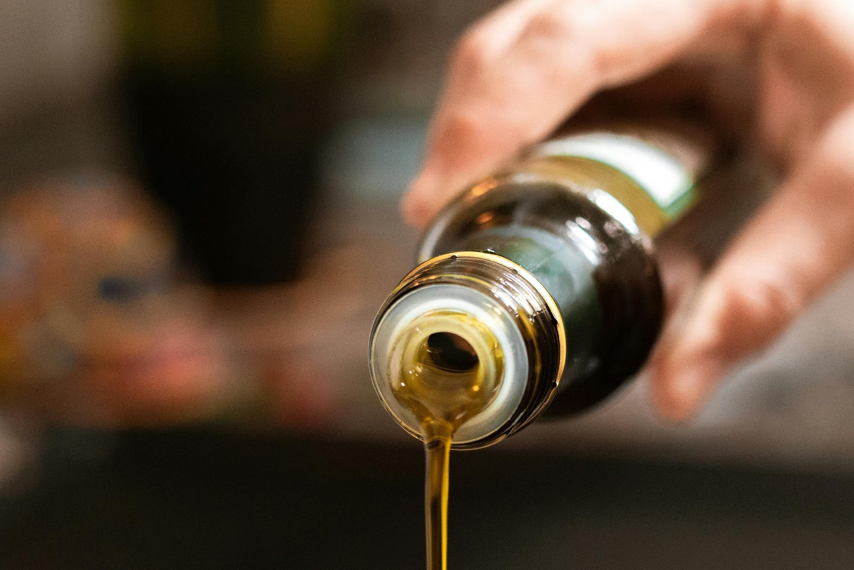 a person pouring oil