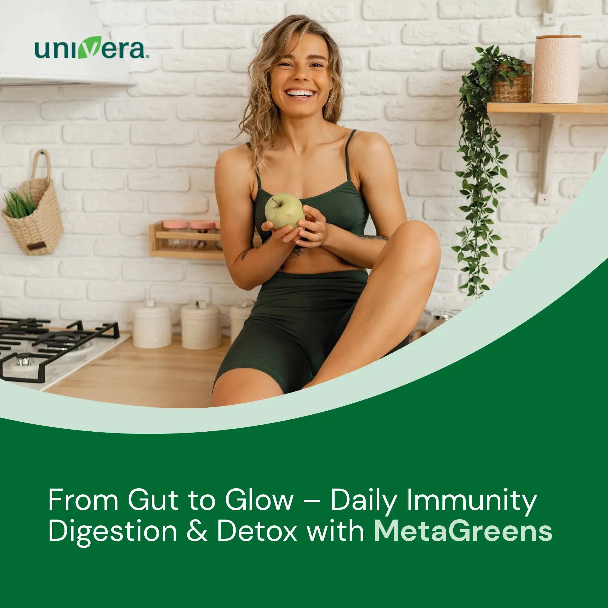 Woman holding a green apple in a kitchen with 'univera' branding and promotional text about MetaGreens.